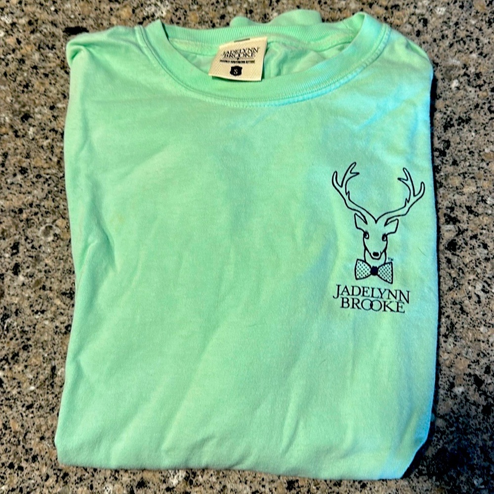 Small, teal, long sleeve shirt.